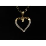 A 9 carat yellow gold and diamond heart-shaped pendant, suspended on a 9 carat yellow gold chain.