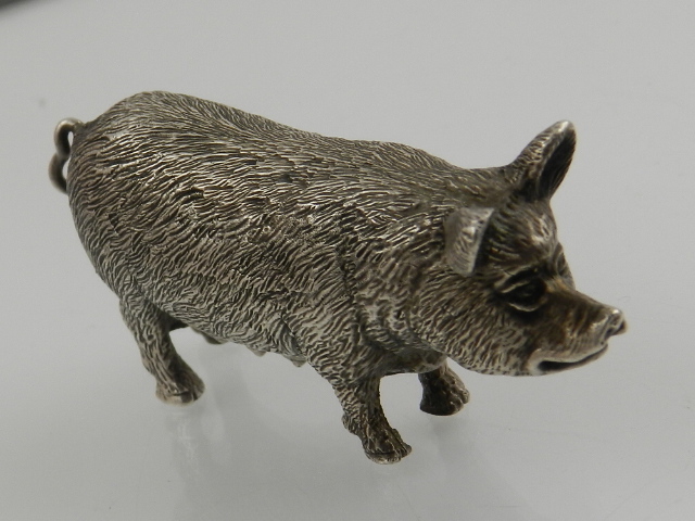 A silver figurine modelled as a pig, hallmarked London 1999,