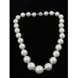 An 18ct white gold graduated cultured pearl necklace, with diamond ball clasp.