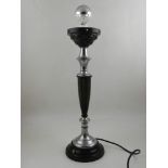 An early 20th century black bakelite and chrome mounted table lamp, with a fluted tapering column,