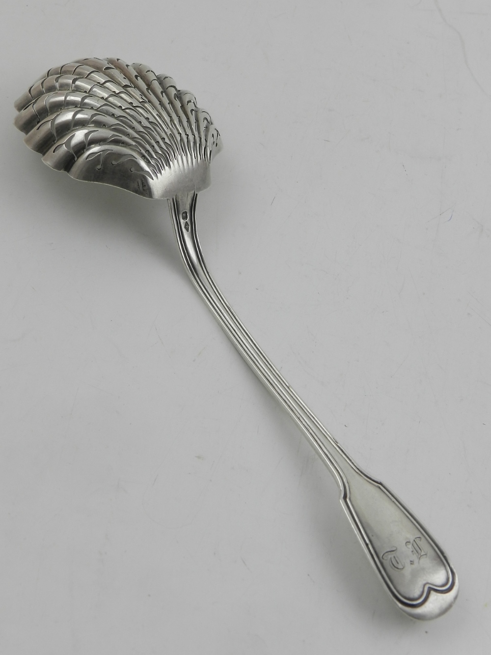 A Large silver fret cut sugar sifter spoon, indistinct hallmark, L.