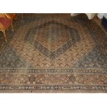 A cream and blue ground Keshan rug, decorated with hexagonal medallion within many medallions,