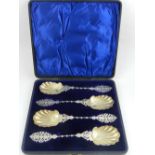 A late 19th century cased set of four large silver plated fruit spoons,