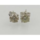 A pair of 14 carat white gold and diamond earstuds, approx 1.2 carat combined, boced and cased.