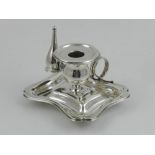 A Dutch white metal candle holder and snuffer,