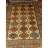 A cream ground Gabbeh rug, decorated with three rows of diamond medallions to centre,