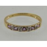 A 9 carat yellow gold, diamond, and amethyst half eternity ring.