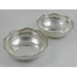 A pair of German white metal baskets, with pierced edges,