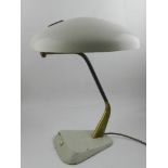 A vintage desk lamp, with a domed cream shade and wedge base and incorporating a brass support, H.