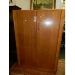 A vintage oak G-plan wardrobe, with a pair of doors enclosing hanging space on a plinth base, W.