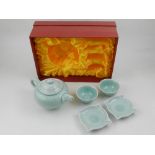 A 20th century boxed tea set, with incised decoration and celedon glaze,