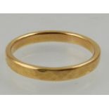 A 22 carat yellow gold band ring, the exterior having a matte finish.