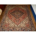 A cream ground Heriz carpet, having stylised floral and tear-drop medallion to centre,