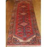 A red ground Kayam runner, decorated with three pole medallion to centre,