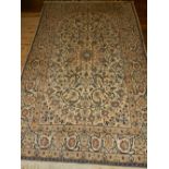 A cream ground Nain carpet, having floral tear-drop medallion to centre, within floral borders,