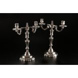 Paire de chandeliers à 2 bras de lumière en métal argenté. De forme balustre à décor de filets et