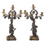Paire de candélabres en bronze	 époque Napoléon III	 à six lumières représentant un couple faunes