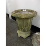 A rustic concrete jardinière on matching rustic stand