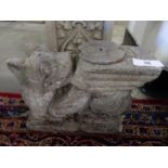 A pair of concrete garden bench ends in the form of griffins