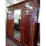 An Edwardian Maple and Co. mahogany and satinwood crossbanded wardrobe fitted centre mirrored door