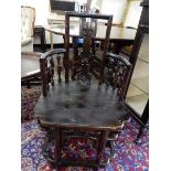 A pair of Chinese hardwood chairs with pierced centre splats, hard seats, pierced aprons, on