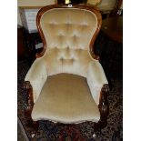 A Victorian armchair in a carved rosewood frame, on cabriole forelegs