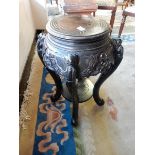 A Chinese ebonised vase stand with circular top, pierced frieze, scroll legs and undertier