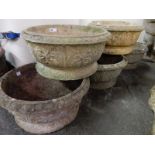 Five matching concrete garden pots with raised decoration of leaves