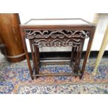 A nest of three Chinese occasional tables with rectangular tops, pierced friezes