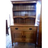 An oak Arts and Crafts style dresser fitted drawer, cupboards under