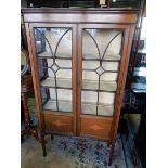 An Edwardian mahogany and satinwood inlaid display cabinet fitted glass panelled door and sides,