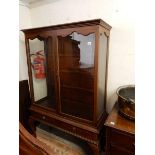 A mahogany display cabinet fitted two glass doors and sides, two frieze drawers, rope carved edge,