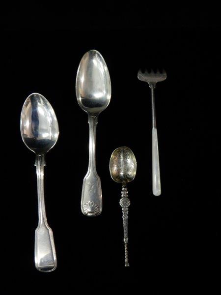 An ornamental silver spoon with Celtic decoration, a silver fork with mother of pearl handle, an