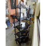 An ebonised five tier whatnot with turned supports