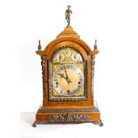 An Edwardian bracket clock with brass dial, pierced spandrels, silvered chapter ring, chime/silent