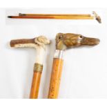 A riding crop with bone handle carved in the form of a dog - 26in long and a walking stick with