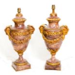 A pair of rouge marble and gilded ormolu mounted urn shaped tablelamp bases with applied rams head