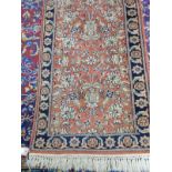 A small Eastern rug, pink field with blue and cream floral pattern - 70in. x 24in. approx.