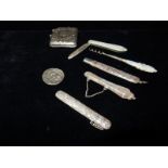 A silver vesta case with engraved decoration, a 'Roman' coin, a silver coloured metal pencil case,