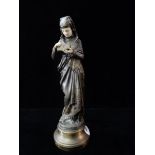 A gilded bronze and ivory figure entitled Liseuse depicting a lady in Medieval dress reading, the