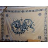 A Chinese cream silk bedspread with blue embroidered decoration of dragons, flowers, mons and