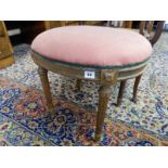 A Victorian walnut framed stool with oval top, on fluted legs