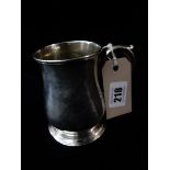 A George II silver mug of baluster form with scroll handle, on circular foot - London 1742, makers