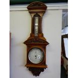 A Victorian barometer and thermometer by James Lucking and Co. on a walnut mount with shell and leaf