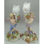 A pair of continental figural candlestic