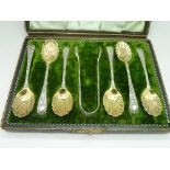 A cased set of plated spoons and sugar b