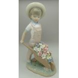 A Lladro figure of a boy and wheelbarrow