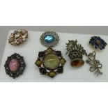 Seven costume brooches