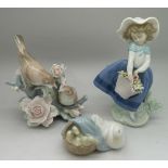 Three Lladro figures; a girl holding a b