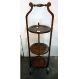 A mahogany three tier cake stand